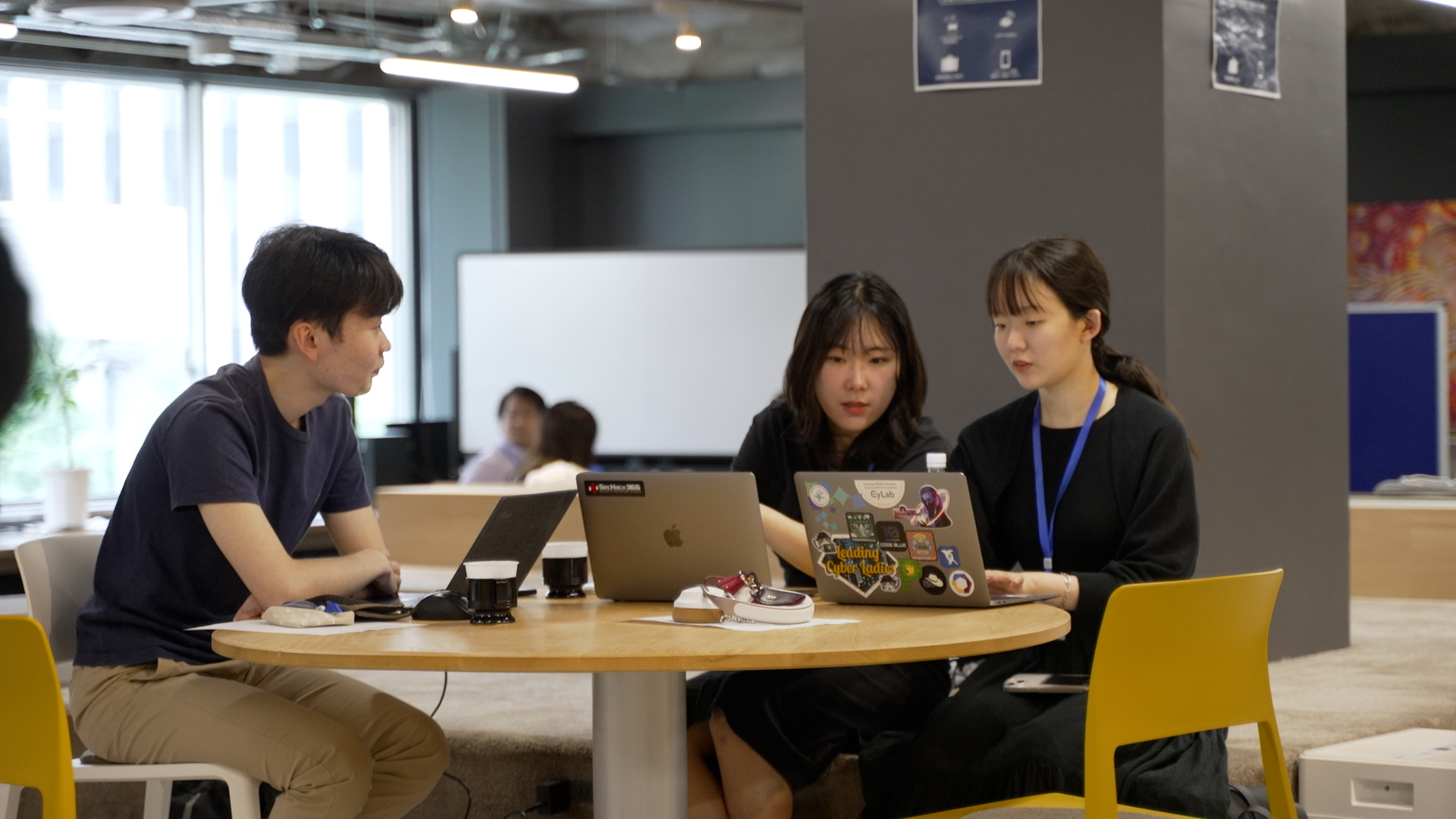 A scene from a hackathon event. A scene of a discussion within the team.