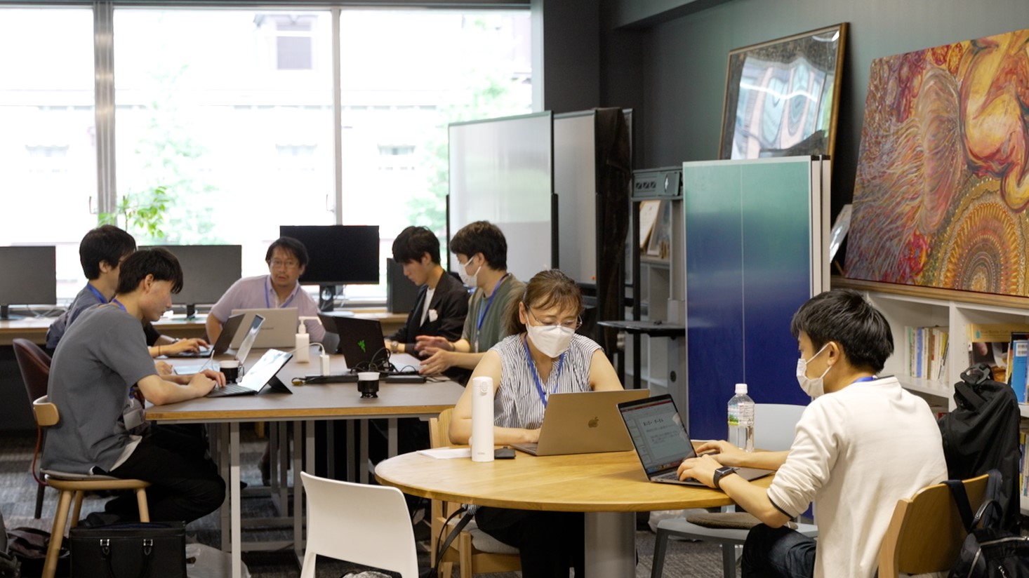 A scene from a hackathon event. A scene of a discussion within the team.