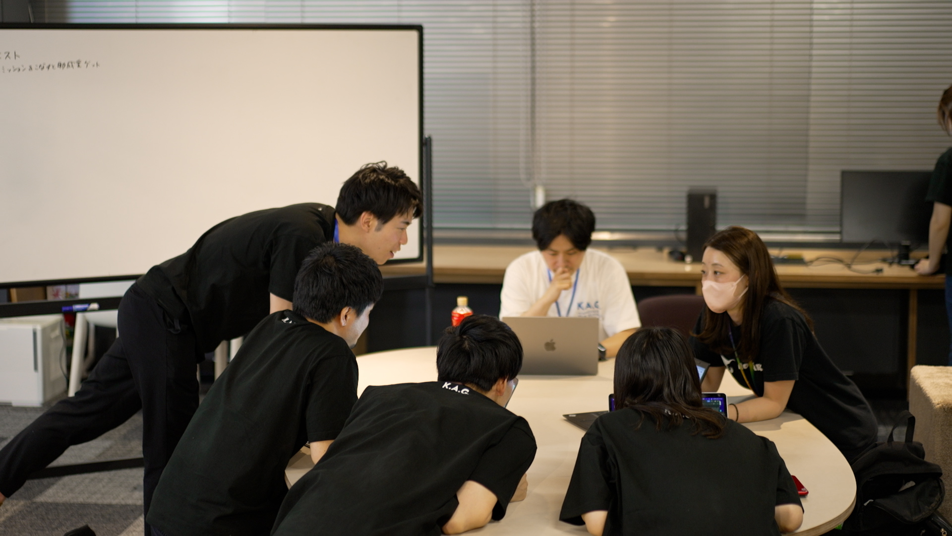 A scene from a hackathon. A scene of a discussion within the team.