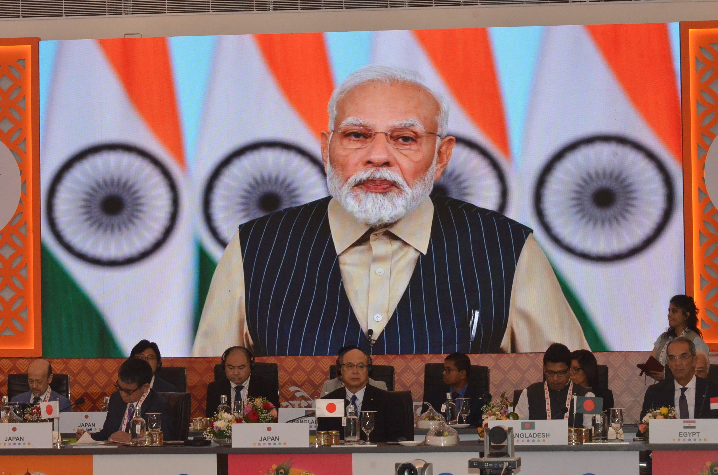 The India's Prime Minister Modi appears on the screen during the meeting.